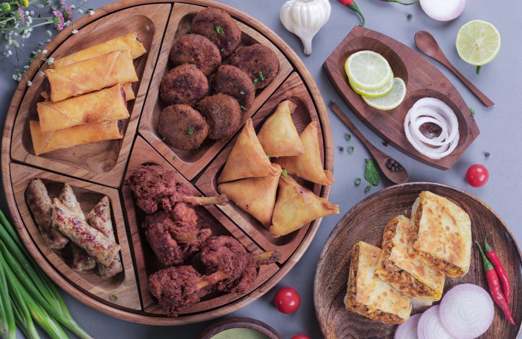Assorted chicken platter with chicken samosas, rolls, lollypops and kebabs