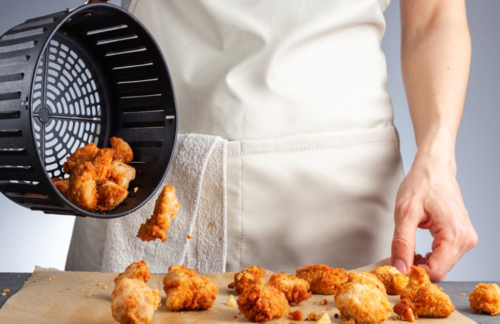 Crispy chicken breast in air fryer basket