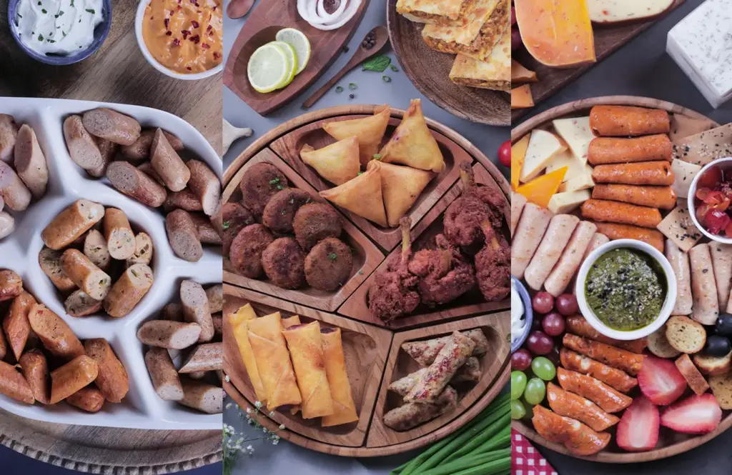 Assorted ready-to-cook chicken platters featuring Zorabian sausages, seekh kebabs, samosas, spring rolls, fried chicken, and cheese snacks arranged on wooden boards with dips, veggies, fruits, and garnishes